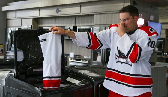 hockey player doing laundry